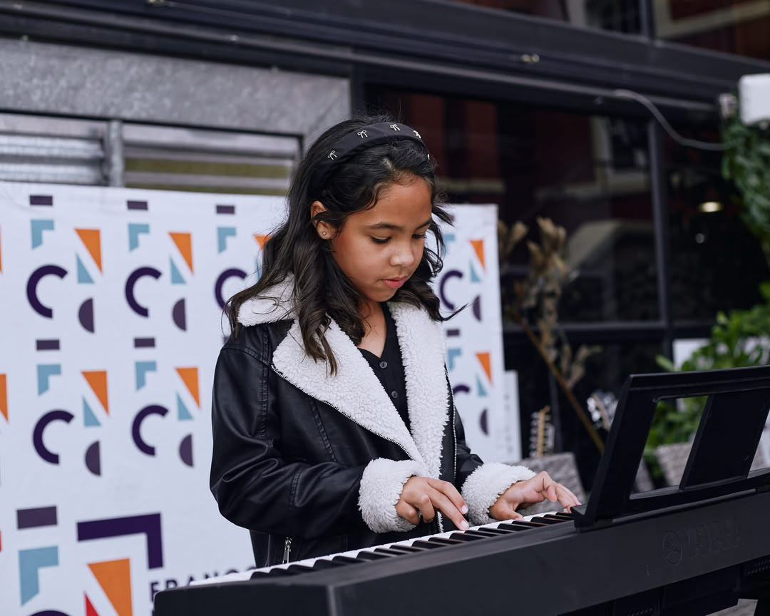 Student performing keyboard on stage